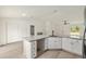 Bright kitchen features granite counters, stainless steel appliances, and white cabinets at 24375 Nw Foxglove Ln, Dunnellon, FL 34431
