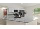 Bright kitchen features granite countertops, stainless steel appliances, and white cabinets at 24375 Nw Foxglove Ln, Dunnellon, FL 34431