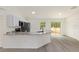Open kitchen features granite counters, stainless appliances, and sliding glass doors at 24375 Nw Foxglove Ln, Dunnellon, FL 34431
