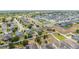 Bird's eye perspective of a suburban neighborhood with uniform landscaping, fences, and solar panels on roofs at 4013 Ruby Run, Haines City, FL 33844