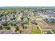 High-angle view of a residential area, highlighting neat streets and a mix of homes with solar panels and green lawns at 4013 Ruby Run, Haines City, FL 33844