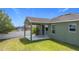 A covered patio provides the perfect outdoor space in this grassy backyard at 4013 Ruby Run, Haines City, FL 33844