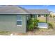 A covered patio with palm tree accents enhance this lovely home's backyard at 4013 Ruby Run, Haines City, FL 33844