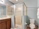 Bathroom with glass enclosed shower, vanity, and convenient toilet at 4013 Ruby Run, Haines City, FL 33844
