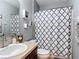 Bathroom featuring dark vanity, gray walls, and patterned shower curtain at 4013 Ruby Run, Haines City, FL 33844