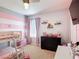 Bedroom featuring carpeted floors, bunk beds, and plush wall decor at 4013 Ruby Run, Haines City, FL 33844