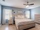 A beautifully decorated bedroom featuring a ceiling fan, neutral color scheme, and natural light at 4013 Ruby Run, Haines City, FL 33844
