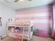 Bedroom featuring carpeted floors, bunk beds, and striped wall decor at 4013 Ruby Run, Haines City, FL 33844