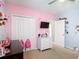 Bedroom featuring carpeted floors, closet, storage, and TV at 4013 Ruby Run, Haines City, FL 33844