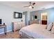 Modern bedroom features an entertainment area and convenient access to an ensuite bathroom at 4013 Ruby Run, Haines City, FL 33844