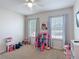 Bedroom with carpeted floors, ceiling fan, and bright windows at 4013 Ruby Run, Haines City, FL 33844