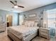 Comfortable bedroom offers a ceiling fan, stylish furniture, and ensuite bathroom at 4013 Ruby Run, Haines City, FL 33844