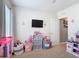 Bedroom featuring carpeted floors, toys, storage and TV at 4013 Ruby Run, Haines City, FL 33844