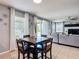 Well-lit dining area with a wood table, tile flooring, and direct access to the living room at 4013 Ruby Run, Haines City, FL 33844
