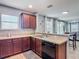 Well-maintained kitchen featuring dark wood cabinets and black appliances, with an adjacent dining area at 4013 Ruby Run, Haines City, FL 33844