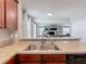 Bright kitchen featuring stainless steel sink, granite counters, and open view to the living area at 4013 Ruby Run, Haines City, FL 33844