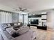 Spacious living room features a ceiling fan, large television, and comfortable sectional sofa at 4013 Ruby Run, Haines City, FL 33844