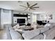 Comfortable gray sectional sofa faces an entertainment center in the open living room area at 4013 Ruby Run, Haines City, FL 33844