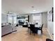 Open concept living and dining area with tile floors, grey sofa and modern decor at 4013 Ruby Run, Haines City, FL 33844