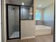 This bathroom features a walk-in shower and soaking tub, with natural lighting from the window at 4424 Sw Viola Ct, Dunnellon, FL 34431