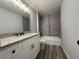 Bathroom with a vanity, granite countertop, and a shower with a tub and tile surround at 4424 Sw Viola Ct, Dunnellon, FL 34431