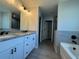Modern bathroom features a double vanity with granite countertop and modern fixtures at 4424 Sw Viola Ct, Dunnellon, FL 34431