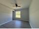 Inviting bedroom with a modern ceiling fan, vinyl plank flooring, and a window view at 4424 Sw Viola Ct, Dunnellon, FL 34431