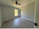 Cozy bedroom featuring laminate flooring, neutral paint, ceiling fan, and a window with a view at 4424 Sw Viola Ct, Dunnellon, FL 34431