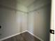 Empty walk-in closet features laminate floors and wire rack shelving for storage solutions at 4424 Sw Viola Ct, Dunnellon, FL 34431