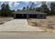 New construction single-story home featuring attached two-car garage and low-pitched roof at 4424 Sw Viola Ct, Dunnellon, FL 34431