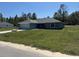 Inviting single-story home showcasing a lush green lawn, attached garage, and a serene neighborhood at 4424 Sw Viola Ct, Dunnellon, FL 34431