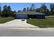Charming single-story home with a well-manicured lawn, attached two-car garage, and a concrete driveway at 4424 Sw Viola Ct, Dunnellon, FL 34431