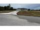Single-story home featuring neutral-colored exterior, a wide driveway, and a neatly maintained lawn at 4424 Sw Viola Ct, Dunnellon, FL 34431