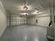 Spacious garage boasts an epoxy floor, ample lighting, and room for parking and storage at 4424 Sw Viola Ct, Dunnellon, FL 34431