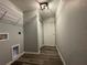 Hallway laundry room with laminate flooring, wire rack, and a closet at 4424 Sw Viola Ct, Dunnellon, FL 34431
