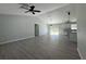 Open-concept living room featuring wood flooring, high ceilings, and plenty of natural light at 4424 Sw Viola Ct, Dunnellon, FL 34431