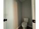 This powder room contains a toilet with laminate floors at 4424 Sw Viola Ct, Dunnellon, FL 34431