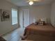 Cozy bedroom with a plush bed and decorative artwork above the bed at 4677 Nw 46Th Ave, Ocala, FL 34482