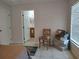 Bedroom featuring tile floors and a sitting area with a chair and storage at 4677 Nw 46Th Ave, Ocala, FL 34482