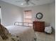 Cozy bedroom features a comfortable bed and dresser with a round decorative mirror at 4677 Nw 46Th Ave, Ocala, FL 34482