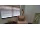 Cozy bedroom with a cushioned chair, window blinds, and serene natural light at 4677 Nw 46Th Ave, Ocala, FL 34482