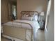 Comfortable bedroom with a stylish bed, cozy bedding, and a nightstand with lamp at 4677 Nw 46Th Ave, Ocala, FL 34482