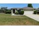 Single-story home featuring a well-maintained lawn, mature landscaping, and an attached two-car garage at 4677 Nw 46Th Ave, Ocala, FL 34482