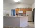 Bright kitchen with wooden cabinets, white appliances, and charming decorative accents above cabinets at 4677 Nw 46Th Ave, Ocala, FL 34482