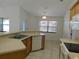 Kitchen featuring breakfast bar, tiled floors, and open layout into other rooms at 4677 Nw 46Th Ave, Ocala, FL 34482