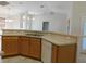 Kitchen with breakfast bar, tiled floors, and neutral countertops at 4677 Nw 46Th Ave, Ocala, FL 34482