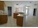 Well-lit kitchen with breakfast bar, tile flooring, and ample counter space at 4677 Nw 46Th Ave, Ocala, FL 34482