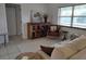 Comfortable living room with a rustic cabinet, cozy chair, and ample natural light at 4677 Nw 46Th Ave, Ocala, FL 34482