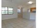 Open-concept living room showcasing tile floors, high ceilings, and a view of the kitchen at 4677 Nw 46Th Ave, Ocala, FL 34482