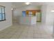 Bright living room area with tile floors, breakfast bar, and view of the kitchen appliances at 4677 Nw 46Th Ave, Ocala, FL 34482